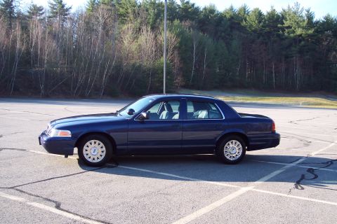 2001 Ford Crown Victoria - This 2001 Ford Crown Victoria is captured in a side profile, its classic sedan body style.