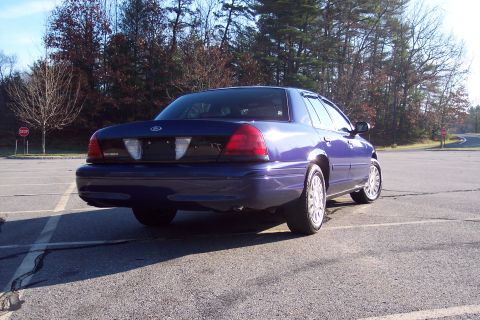 2001 Ford Crown Victoria - Rear view of a blue 2001 Ford Crown Victoria sedan in a parking lot.