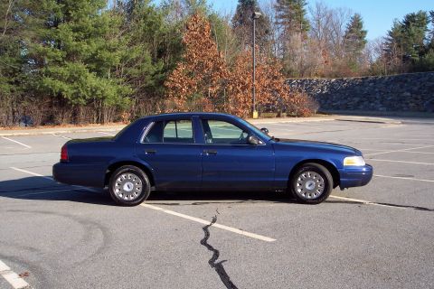 2001 Ford Crown Victoria - Blue 2001 Ford Crown Victoria parked in a lot on a sunny day.