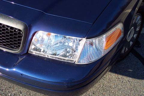 2001 Ford Crown Victoria - Close-up of the front corner of a 2001 Ford Crown Victoria, highlighting the headlight assembly and grille detail.