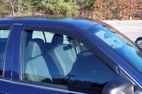 2001 Ford Crown Victoria - Interior view of a blue 2001 Ford Crown Victoria, focusing on the front seats and door frame.