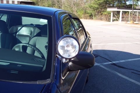 2001 Ford Crown Victoria - A dark blue 2001 Ford Crown Victoria is seen from the front passenger side, equipped with a spotlight.
