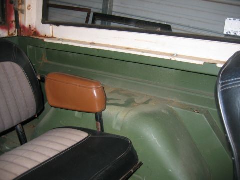 1992 Ford Mustang - The interior of a vintage Ford Bronco reveals its age with visible wear and tear on the seats and body panels.