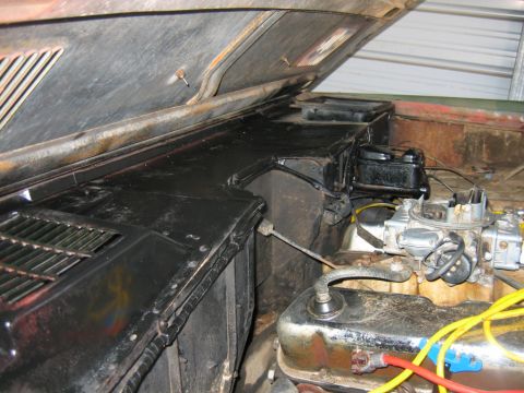 1992 Ford Mustang - Engine bay of an older project 4x4 with the black louvered hood propped open, showing a four-barrel carburetor on an aluminum intake, chrom…