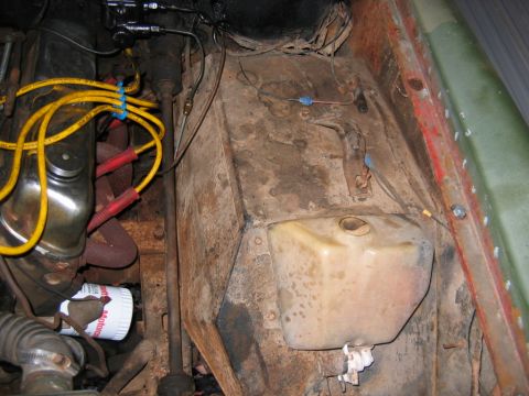 1992 Ford Mustang - Passenger-side engine bay detail of an older project vehicle, showing a yellowed plastic washer-fluid reservoir mounted on a rusty inner fe…