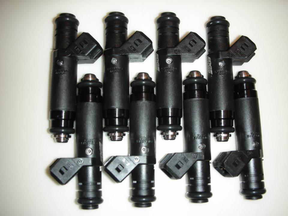 Set of eight black fuel injectors with electrical connectors