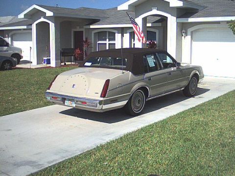 1987 Lincoln Continental - This 1987 Lincoln Continental Mark VII is parked on a concrete driveway with a house in the background.