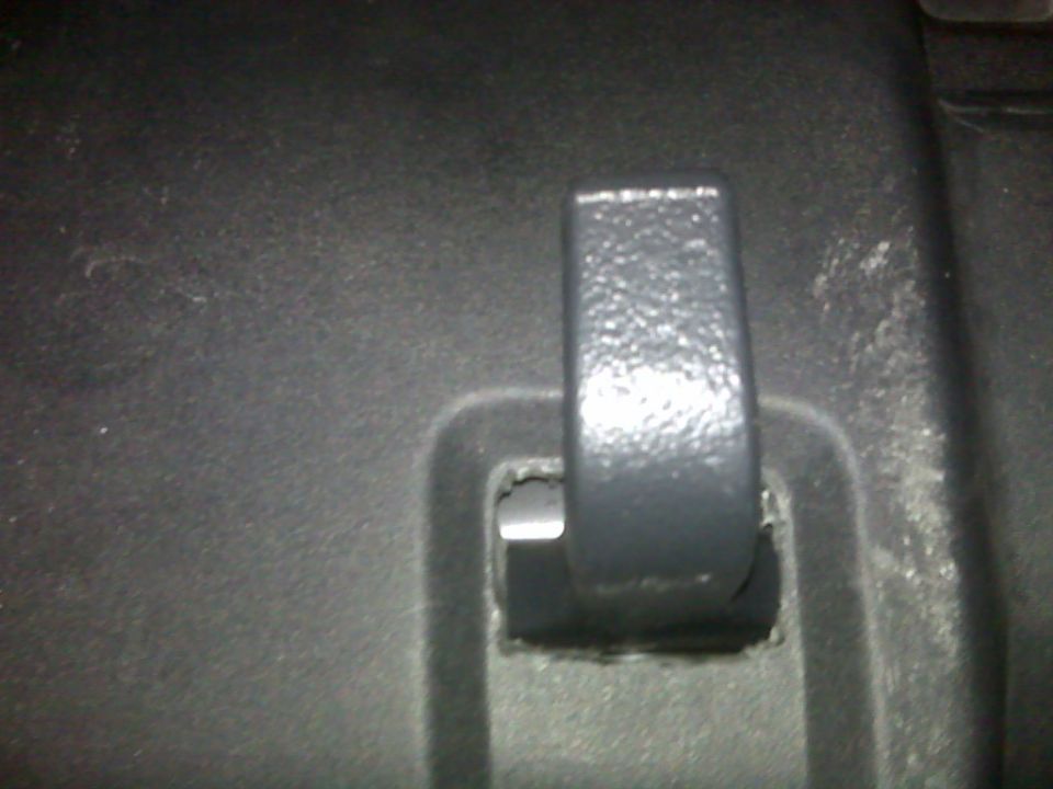 Black plastic tow hook mounted in a textured black plastic recess