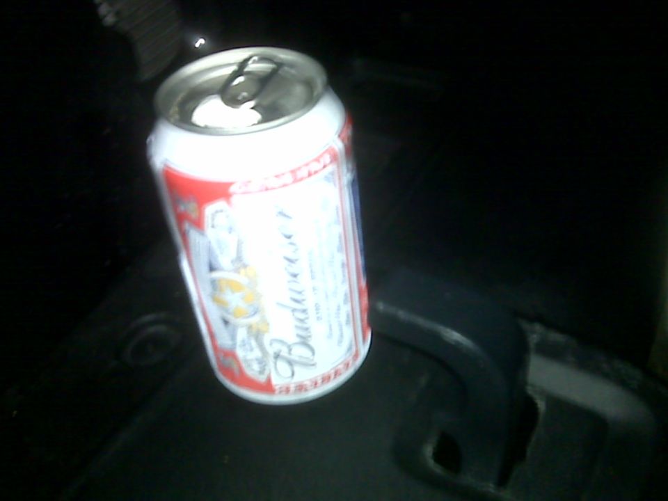Budweiser can on dark surface