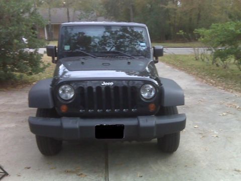 2008 Jeep Wrangler - Front view of a black Jeep Wrangler parked on a driveway.