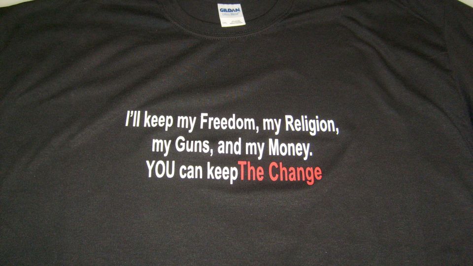 Black t-shirt with text: "I'll keep my Freedom, my Religion, my Guns, and my Money. YOU can keep The Change"