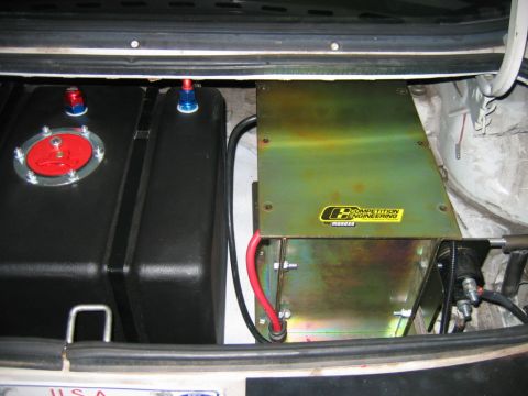 1992 Ford Mustang - Aftermarket fuel cell and Competition Engineering battery box installed in the trunk of a vehicle.
