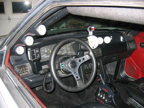 1992 Ford Mustang - Interior view of a 1992 Ford Mustang, multiple aftermarket gauges and a performance shifter.