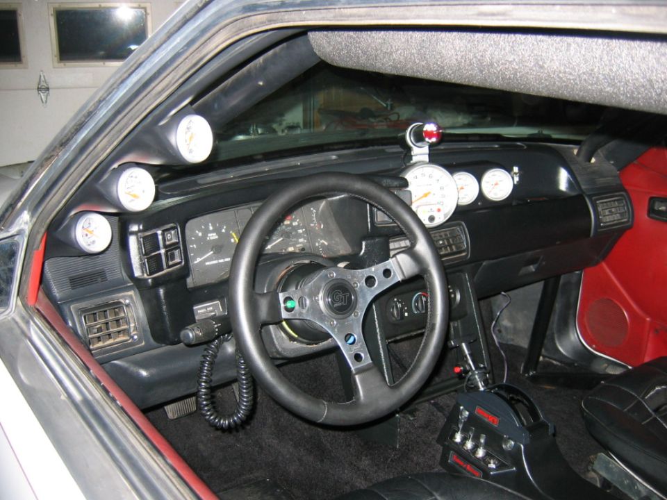 1992 Ford Mustang interior showing aftermarket gauges and racing shifter