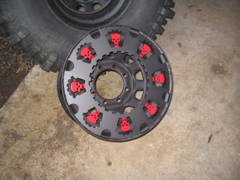 1989 Ford Bronco - A custom wheel with skull accents is shown next to a tire.