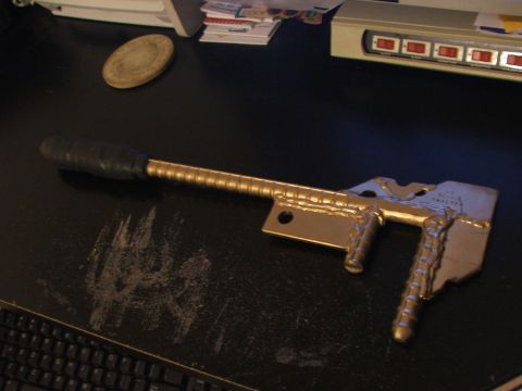 1965 Ford Mustang - Custom fabricated metal part with a gold finish and black grip.