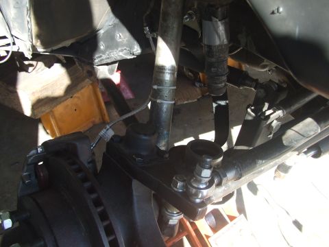 1994 Jeep Cherokee - Close-up view of the front suspension and steering linkage, showing various mechanical parts.