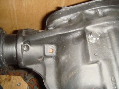 1992 Ford Bronco - Close-up of a black differential housing with visible bolts and a copper plug.