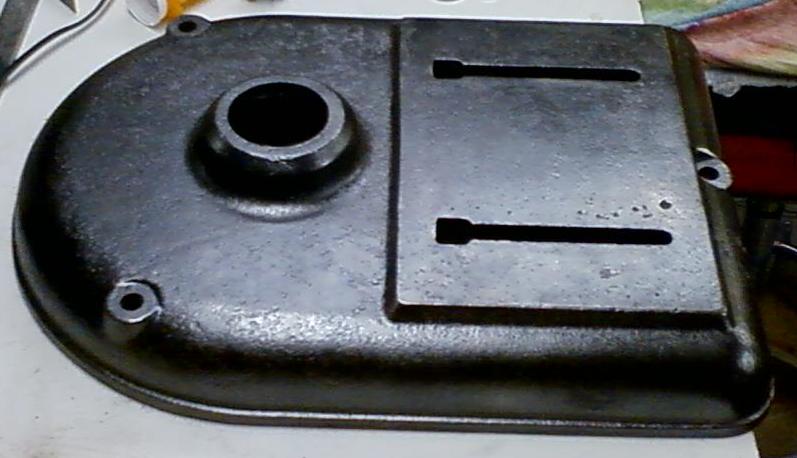 metal cover with a circular hole and two rectangular slots