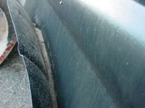 1979 Ford Bronco - Detail of a vehicle's fender and wheel well, highlighting the texture and condition of the bodywork.