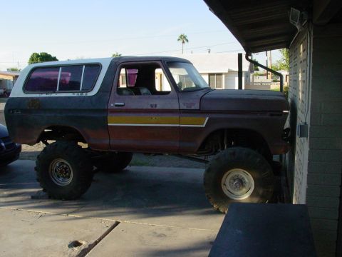 1979 Ford Bronco - This lifted 1978 Ford Bronco is parked close to a building, showing its side profile with a two-tone paint job.
