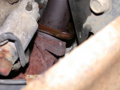 2000 Ford Crown Victoria - Close-up view of a rusted exhaust manifold connection, showing the junction between two metal pipes.