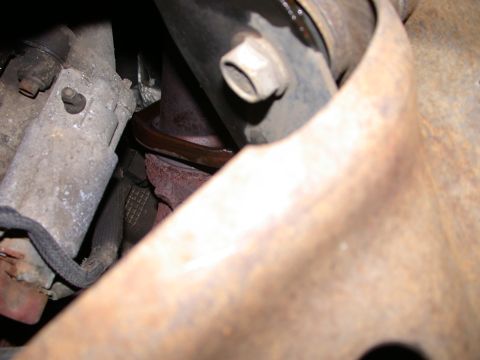 2000 Ford Crown Victoria - Exhaust manifold gasket detail, showing wear and rust on metal parts.