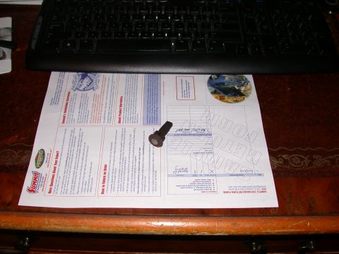 2000 Ford Crown Victoria - A bolt rests on a Summit Racing sample exchange return form, with a keyboard visible above.