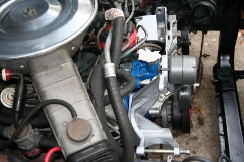 1980 Ford Mustang - The engine compartment is filled with various hoses, belts, and mechanical parts.
