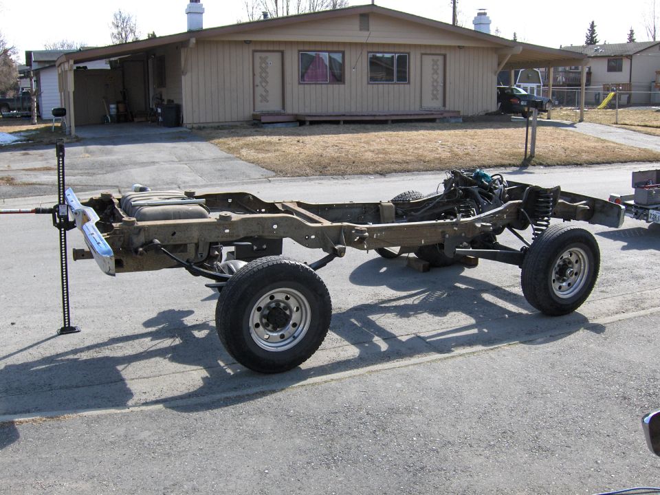 Truck chassis with engine and suspension, jacked up