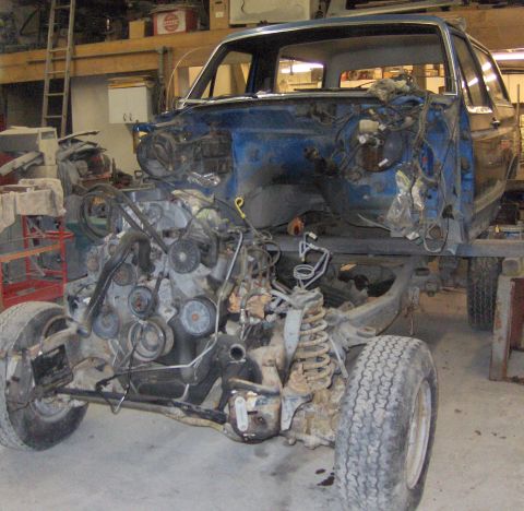 1990 Ford Bronco - This vehicle is undergoing a frame-off restoration, with its engine and chassis prominently displayed.