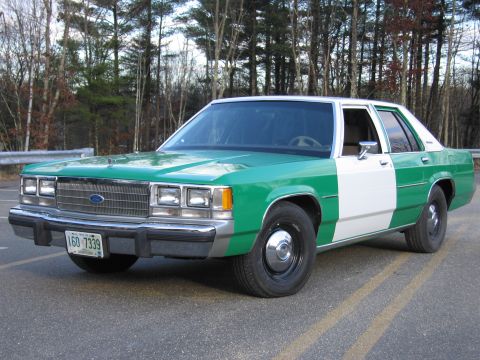 1991 Ford LTD Crown Victoria - Green-and-white two-tone Ford sedan shot from the front quarter, wearing a New Hampshire plate reading 160 7339.