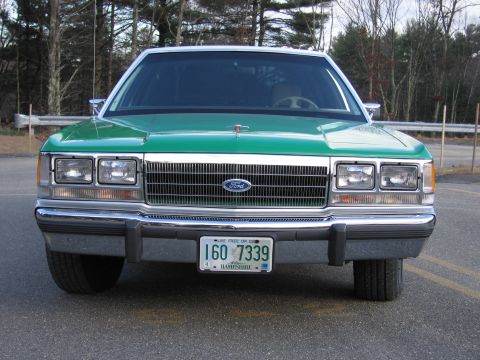 1991 Ford LTD Crown Victoria - Head-on front view of a green Ford sedan with a chrome grille, Ford oval and a New Hampshire plate reading 160 7339.