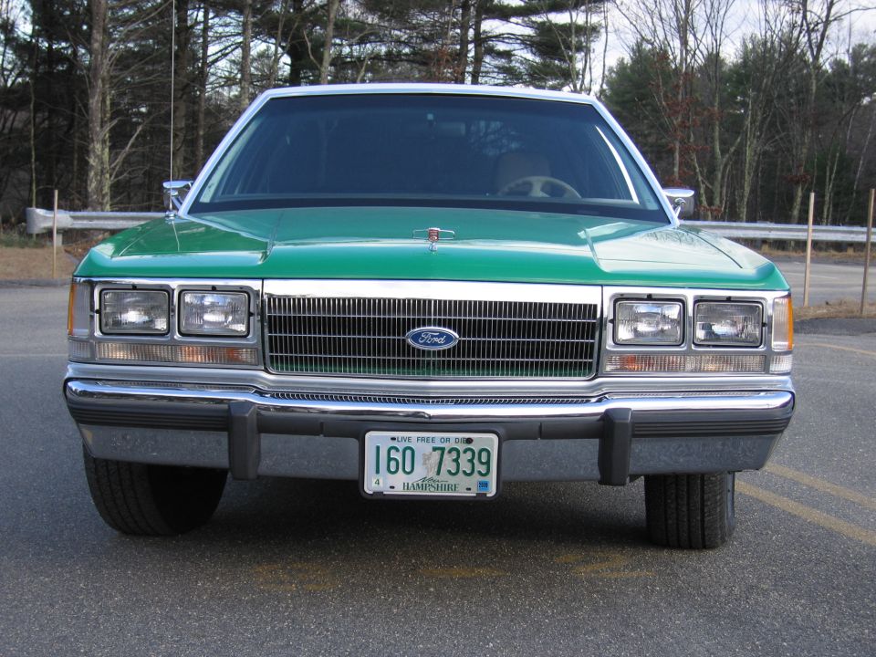 Front of green Ford sedan with NH plate 160-7339, head-on view