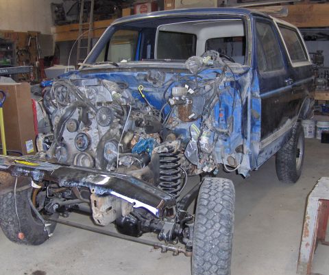 1990 Ford Bronco - This Ford Bronco is undergoing extensive repairs, with its front end completely disassembled.