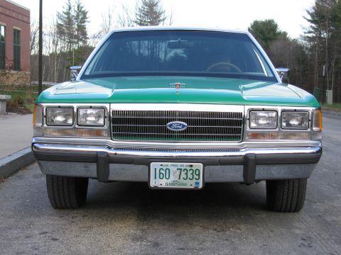 1991 Ford LTD Crown Victoria - Head-on view of the green-and-white Ford sedan's grille, quad headlights and New Hampshire plate reading 160 7339.