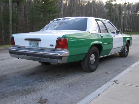 1991 Ford LTD Crown Victoria - Rear passenger-side three-quarter view of the green-and-white Ford sedan wearing New Hampshire plate 160 7339.