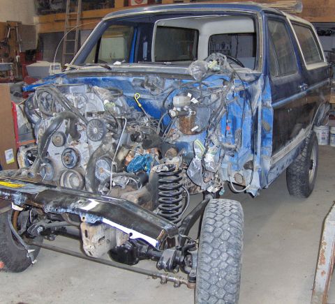 1990 Ford Bronco - This Ford Bronco is undergoing extensive repairs, with its front end completely dismantled.
