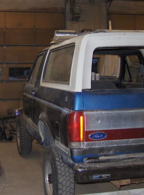 1990 Ford Bronco - Rear view of a 1990 Ford Bronco, showing its body style and Ford badging during a repair process.