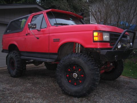 1989 Ford Bronco - This lifted 1989 Ford Bronco features aggressive off-road tires and a custom front bumper, ready for terrain.
