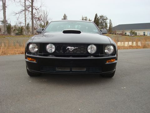 2007 Ford Mustang - Front view of a black 2007 Ford Mustang showing its grille and headlights.