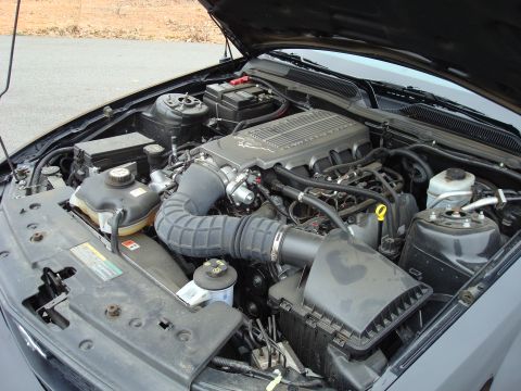 2007 Ford Mustang - The engine bay of a 2007 Ford Mustang, a prominent supercharger.