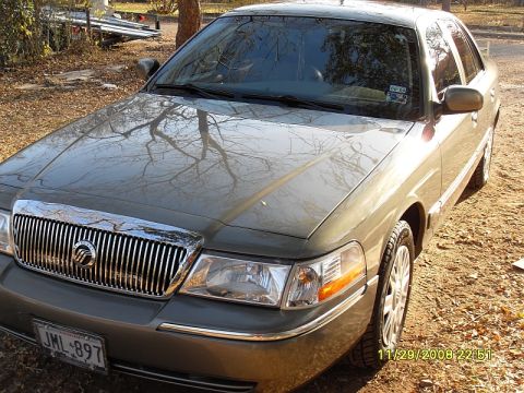 2004 Mercury Marquis - Tan Mercury Grand Marquis parked outdoors on a dirt lot. The date 11/29/2008 is visible in the lower right corner.
