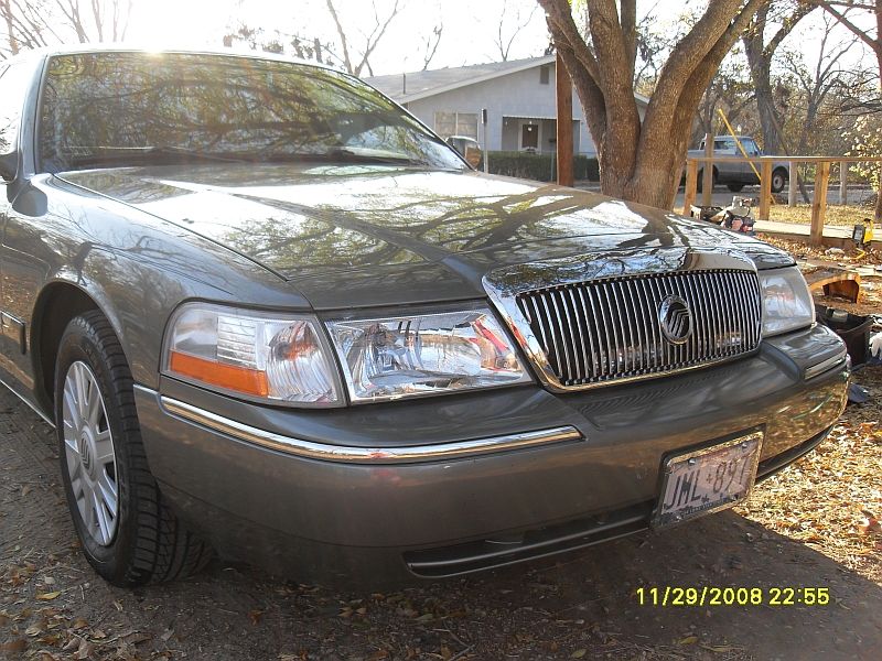 Front view of a gray Mercury Grand Marquis with a chrome grille and license plate JML-897