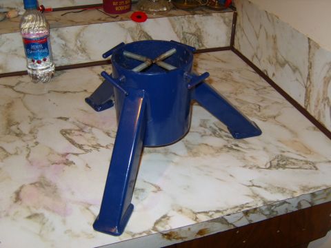 1989 Ford Bronco - A blue metal stand with four legs sits on a marble-patterned countertop next to a bottle of water.