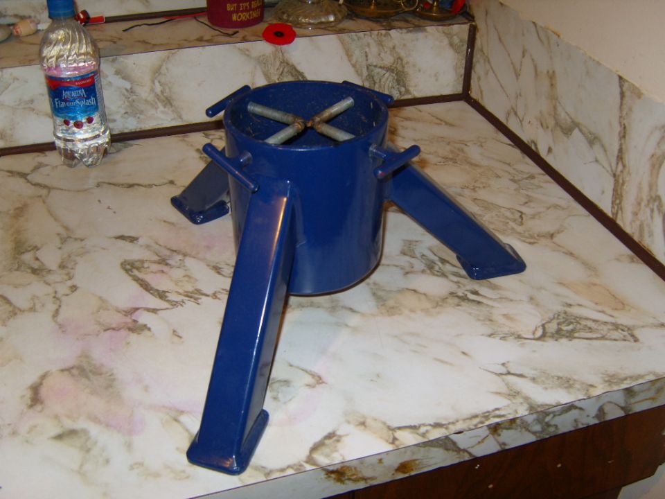 blue metal stand with four legs and crossbars inside top