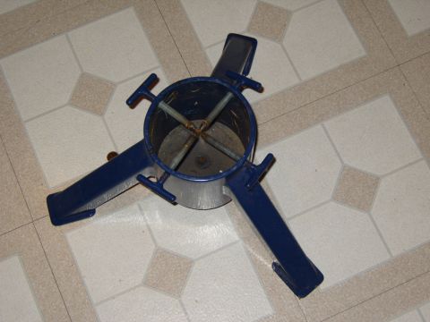 1989 Ford Bronco - A blue metal Christmas tree stand is shown on a tiled floor.