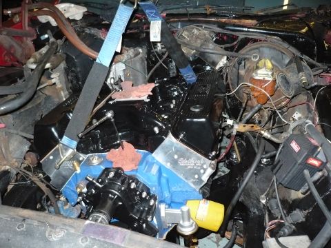 1973 Ford Ranchero - Engine bay work in progress, showing engine components and installation straps.