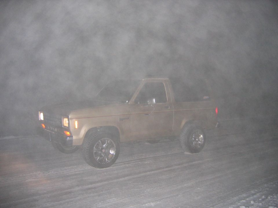 Tan 1984 Ford Bronco II in fog, 3q front view