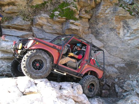 1986 Toyota Hilux - Off-road vehicle tackling a challenging rocky terrain.